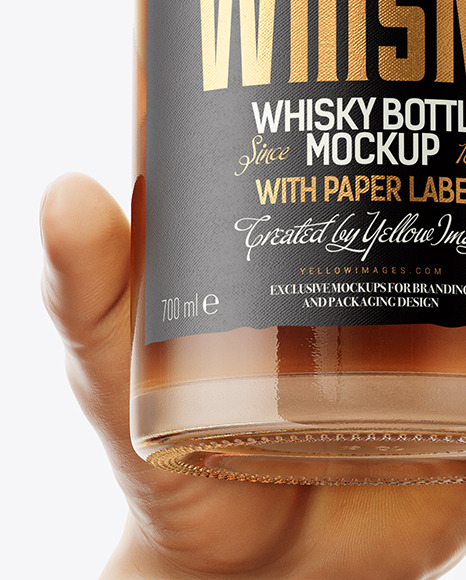 Whisky Bottle in a Hand Mockup