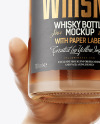 Whisky Bottle in a Hand Mockup