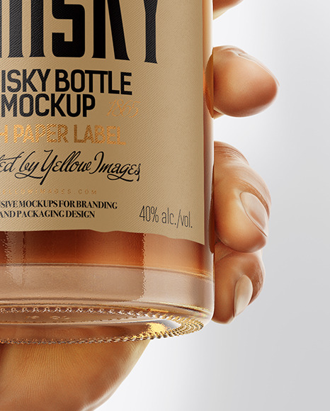 Whisky Bottle in a Hand Mockup