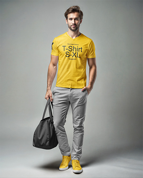 Man Wearing a T-Shirt and Pants with a Bag in His Hand Mockup