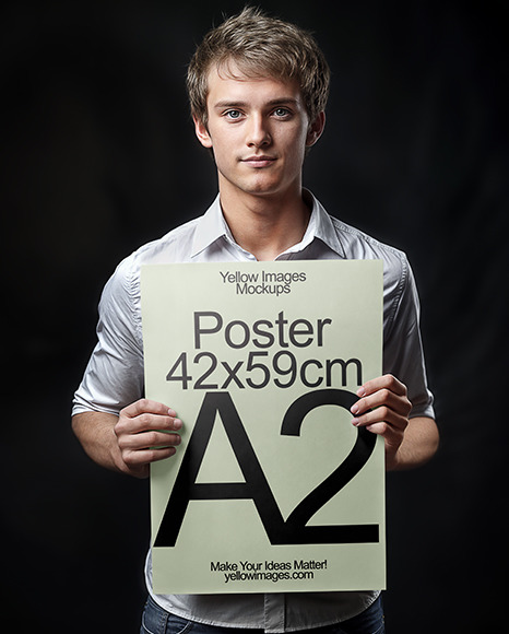 Young Man in White Shirt Holding a Paper Poster Mockup