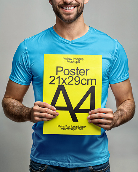 Man in a T-Shirt Holding Paper Poster Mockup