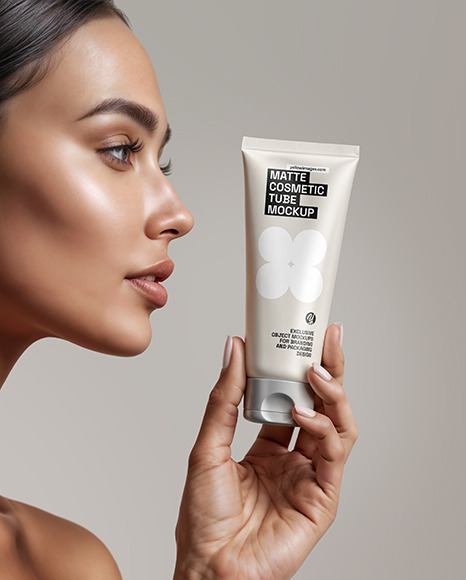 Woman Holding Cosmetic Tube in a Hand Mockup