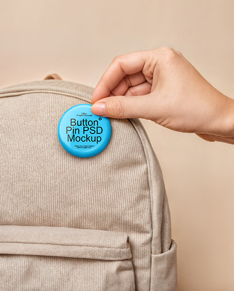 Hand Putting a Button Pin on a Backpack Mockup