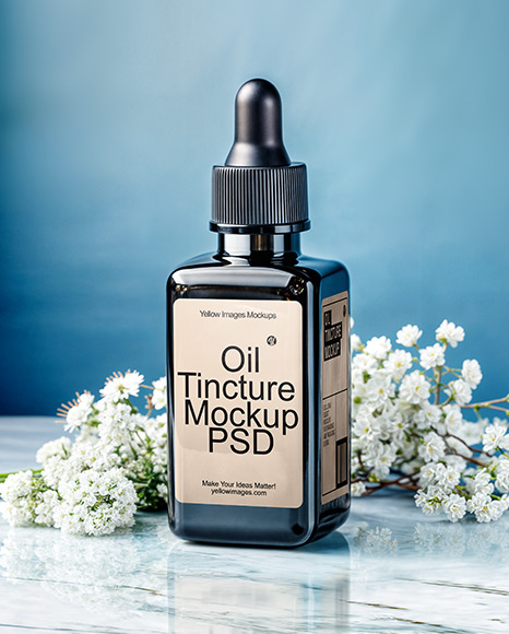 Dark Amber Oil Tincture Square Bottle on a Marble Surface with Flowers Mockup