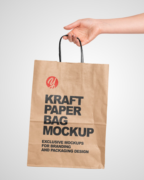 Download Hand Holding a Paper Bag Mockup in Packaging Mockups on Yellow Images Object Mockups