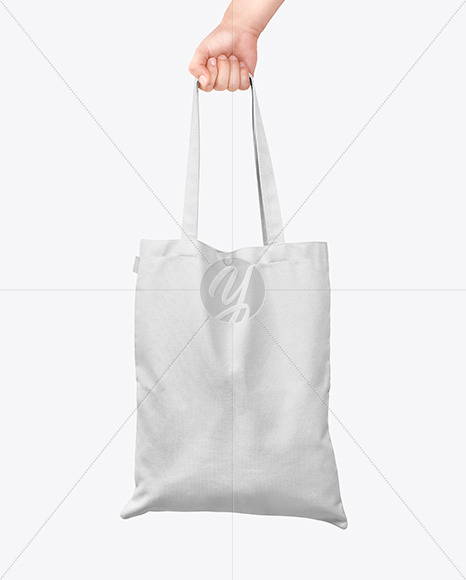 Download Cotton Bag in a Hand Mockup in Apparel Mockups on Yellow ...